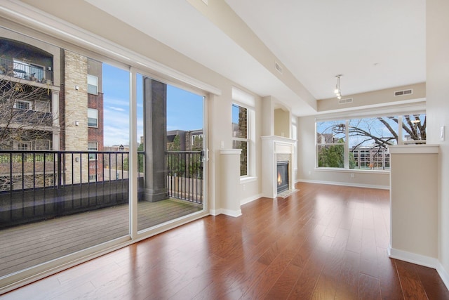 unfurnished living room with wood-type flooring