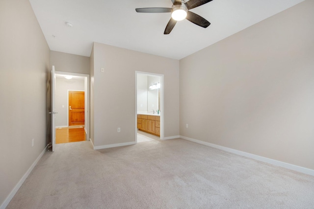 unfurnished bedroom with connected bathroom, ceiling fan, and light colored carpet