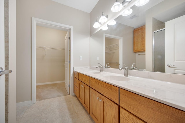 bathroom with tile patterned floors, vanity, and an enclosed shower