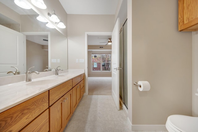 bathroom featuring vanity, a shower with door, ceiling fan, tile patterned flooring, and toilet