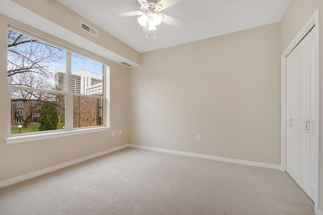 unfurnished bedroom featuring ceiling fan, a closet, and carpet floors