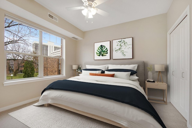 carpeted bedroom with a closet and ceiling fan