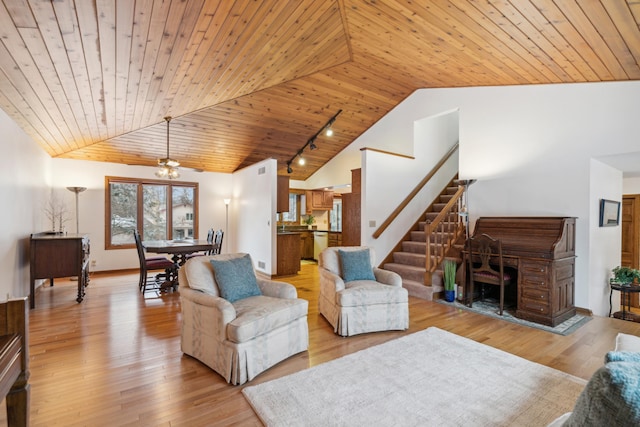 living room with vaulted ceiling, track lighting, light hardwood / wood-style floors, and wooden ceiling