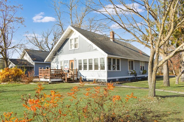 132 6th St NE, Crosby, MN 56441 - rear view of property with a chimney, a deck, a lawn, and a shingled roof