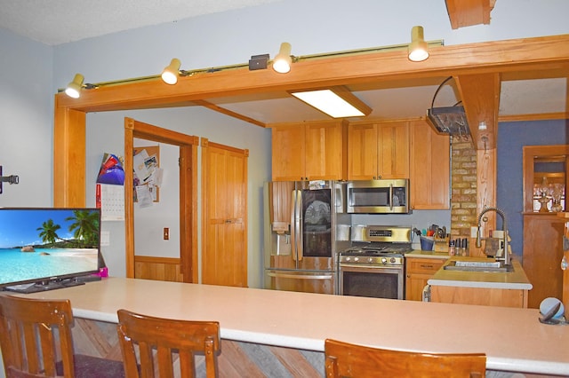 132 6th St NE, Crosby, MN 56441 - kitchen featuring appliances with stainless steel finishes, a sink, and light countertops
