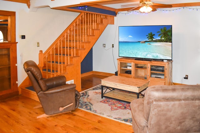 living room featuring hardwood / wood-style floors and ceiling fan