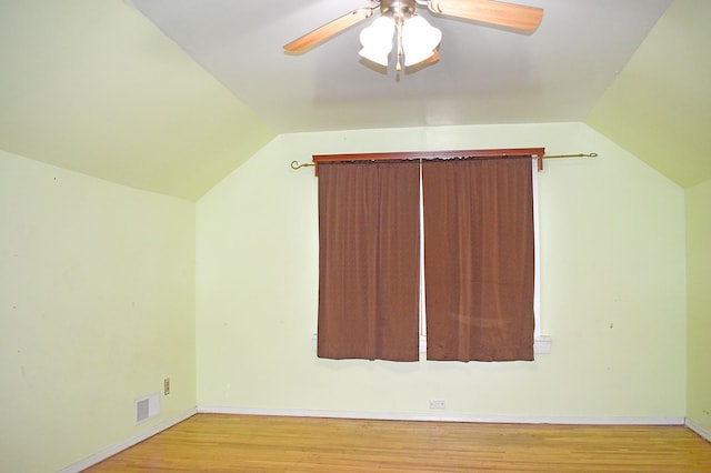 additional living space featuring light hardwood / wood-style floors, vaulted ceiling, and ceiling fan