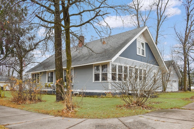 132 6th St NE, Crosby, MN 56441 - view of front facade featuring roof with shingles, a front yard, and a chimney