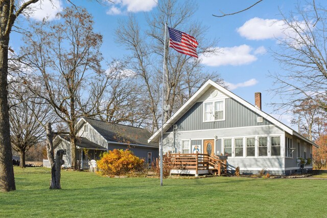132 6th St NE, Crosby, MN 56441 - rear view of property with a deck, a lawn, and a chimney