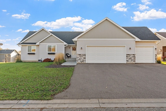 view of front of property with a front yard and a garage