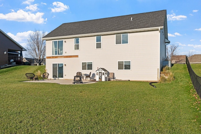 rear view of house with a patio area and a yard