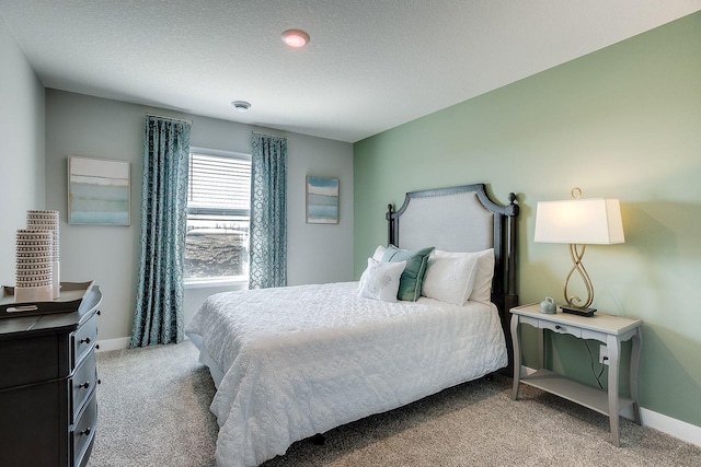 bedroom with light colored carpet and a textured ceiling