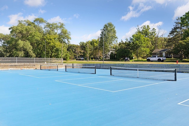 view of sport court featuring fence