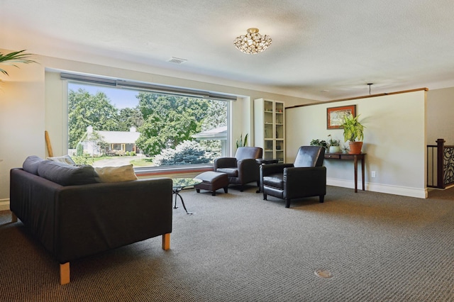 living room with baseboards, carpet, visible vents, and a textured ceiling