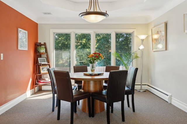 carpeted dining space featuring baseboards, visible vents, and baseboard heating