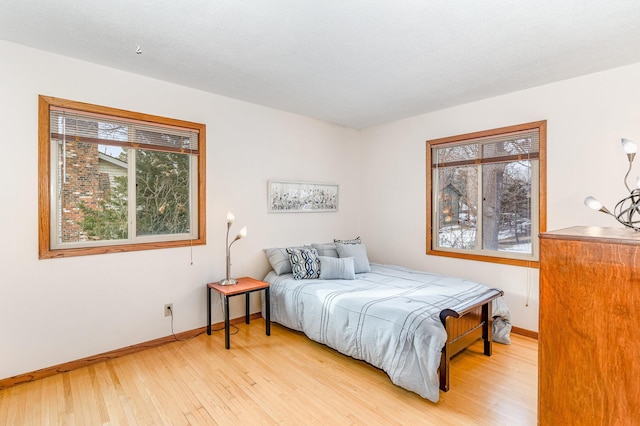 bedroom featuring light wood-style flooring and baseboards