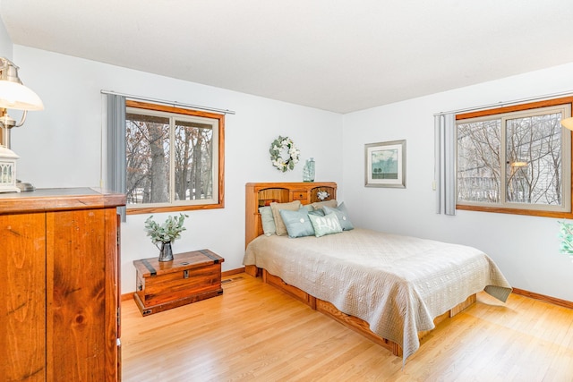 bedroom with light wood-style floors and baseboards