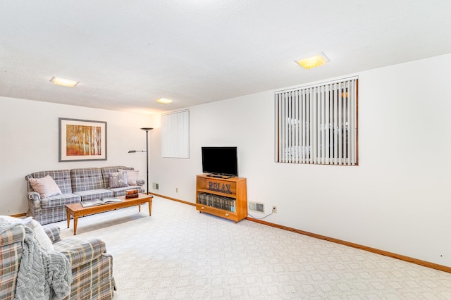 carpeted living room with baseboards and visible vents