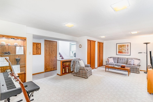 living area featuring stairway, baseboards, and carpet floors