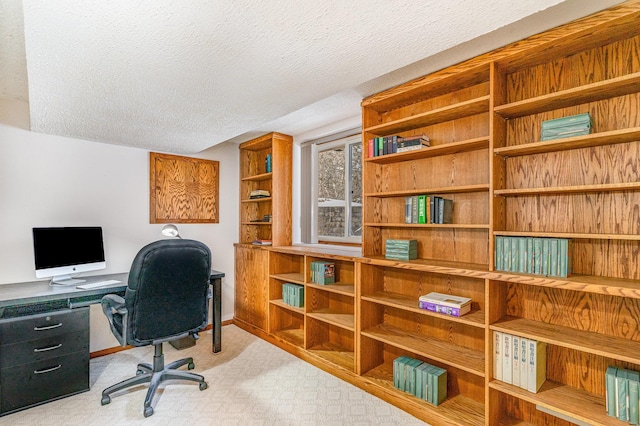 office space with baseboards and a textured ceiling