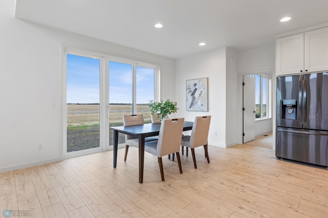 dining area with light hardwood / wood-style floors