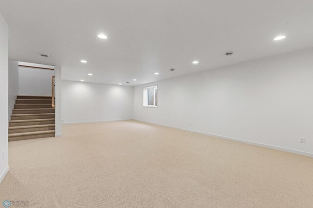 basement featuring light carpet