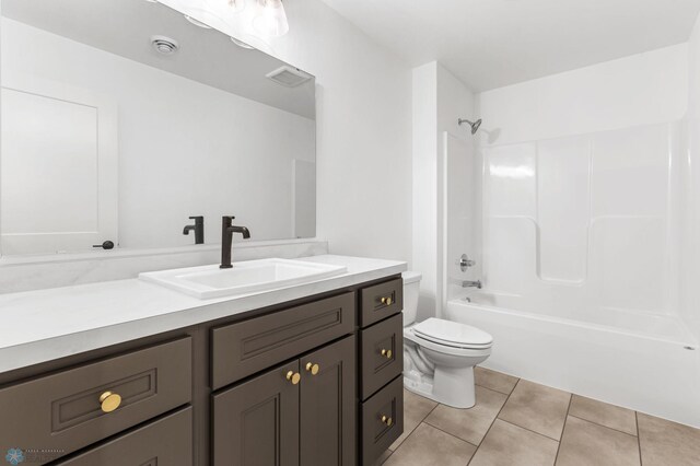 full bathroom featuring toilet, vanity, tile patterned floors, and shower / bathtub combination