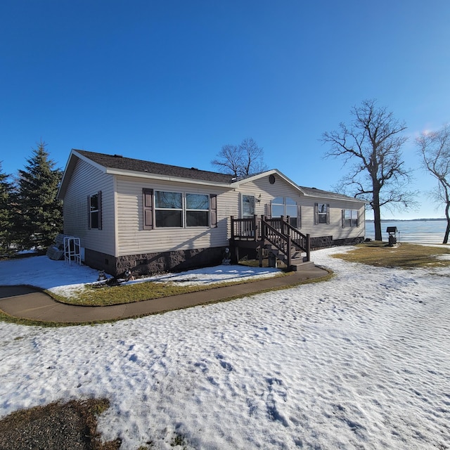 view of front of home with a water view