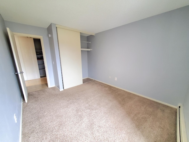 4110 Rahn Rd Unit 215, Eagan, MN 55122 - unfurnished bedroom with a baseboard heating unit, a closet, carpet flooring, and baseboards