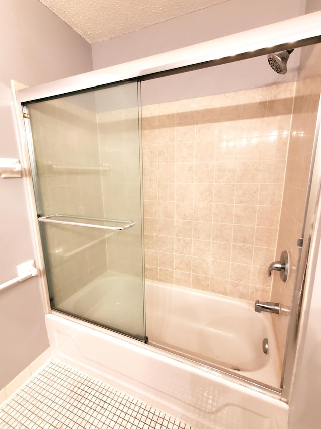 4110 Rahn Rd Unit 215, Eagan, MN 55122 - bathroom with tile patterned floors, a textured ceiling, and shower / bath combination with glass door