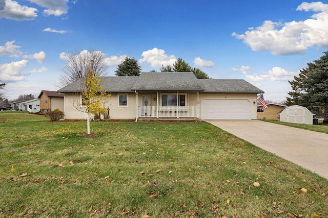 ranch-style house featuring covered porch, a storage unit, a garage, and a front lawn