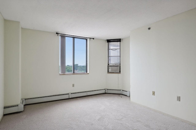 unfurnished room featuring carpet floors, a baseboard radiator, and cooling unit