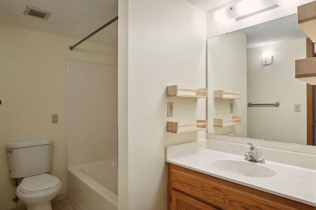 full bathroom featuring vanity, a textured ceiling, toilet, and tub / shower combination