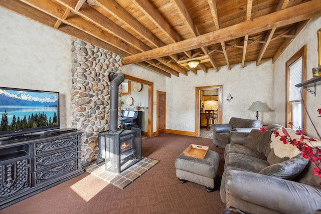 living room with dark carpet, a wood stove, beamed ceiling, and wood ceiling