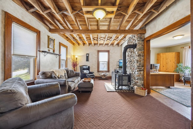 carpeted living room featuring beam ceiling, a wood stove, and wooden ceiling