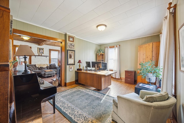 home office featuring wooden walls, crown molding, and light hardwood / wood-style floors