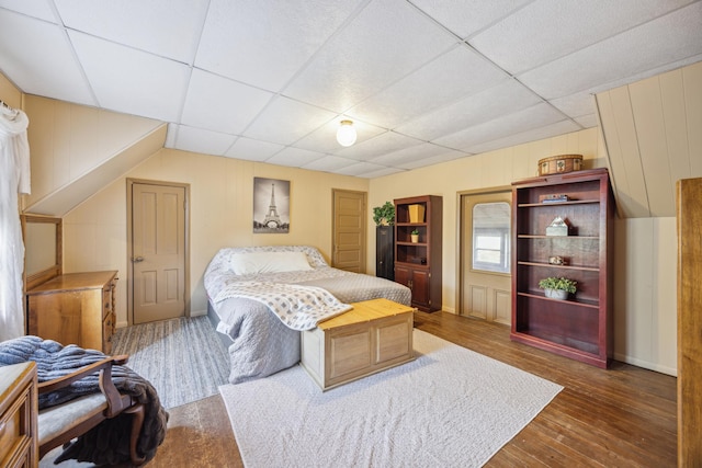 bedroom featuring a paneled ceiling and dark wood-type flooring