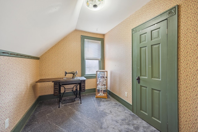 carpeted office with lofted ceiling