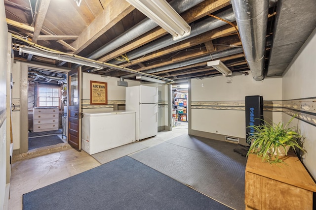 basement with white fridge