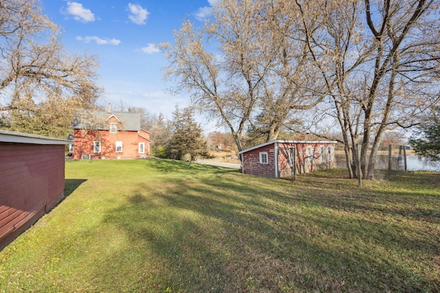 view of yard featuring a water view and an outdoor structure