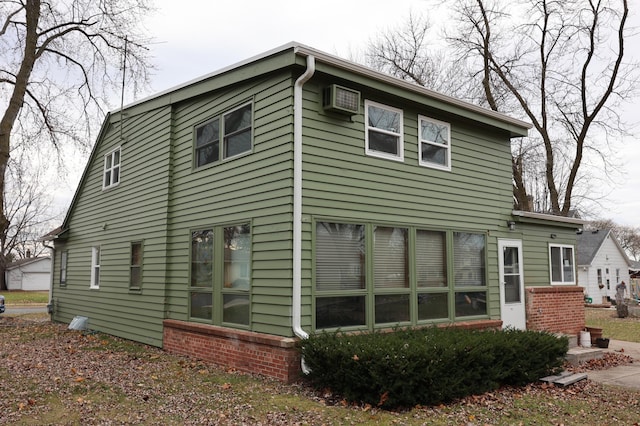 back of property with a wall mounted air conditioner