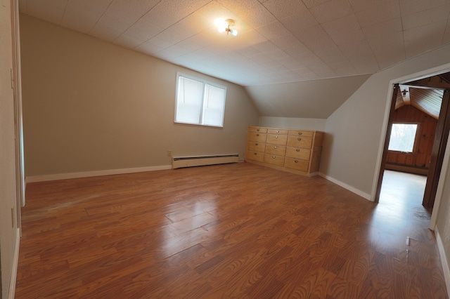 bonus room featuring hardwood / wood-style flooring, lofted ceiling, and a baseboard radiator