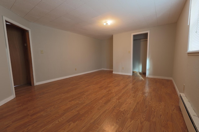 spare room with light hardwood / wood-style floors and baseboard heating