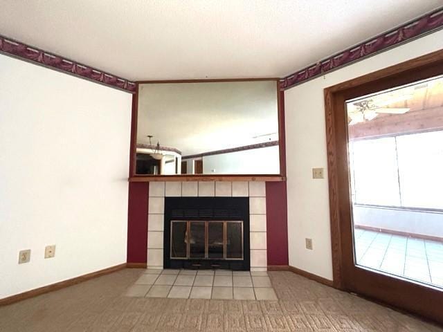 unfurnished living room featuring a tile fireplace