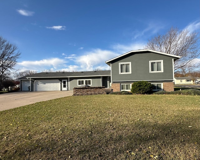 split level home with a garage and a front lawn