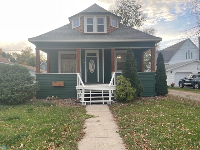 bungalow with a porch and a front yard