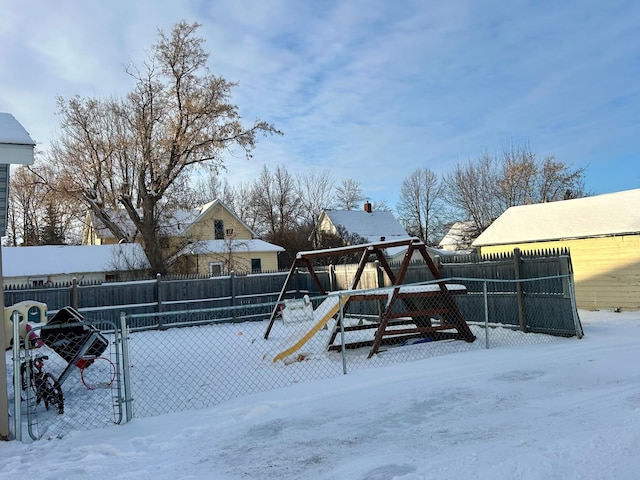 snowy yard with a playground