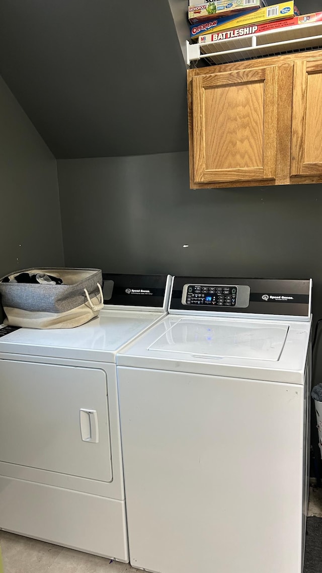 washroom featuring independent washer and dryer and cabinets