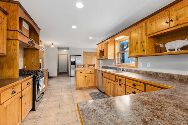 kitchen with light tile patterned flooring, sink, kitchen peninsula, and stainless steel appliances