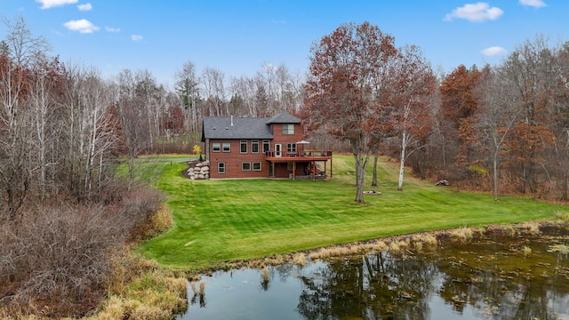 back of property featuring a lawn and a deck with water view